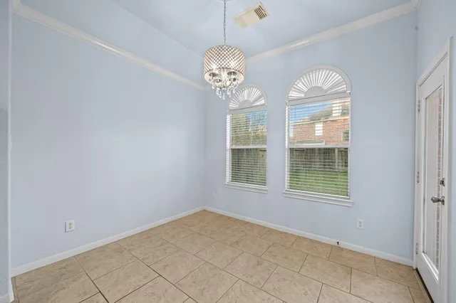 an empty room with a window and ceiling fan