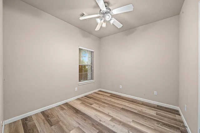 a aerial view of a house next to a big yard and large trees