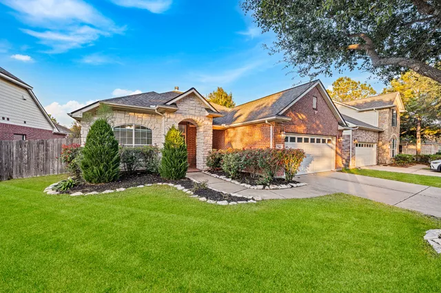 a front view of a house with a garden and swimming pool