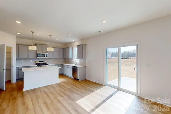 a kitchen with a refrigerator and a stove top oven