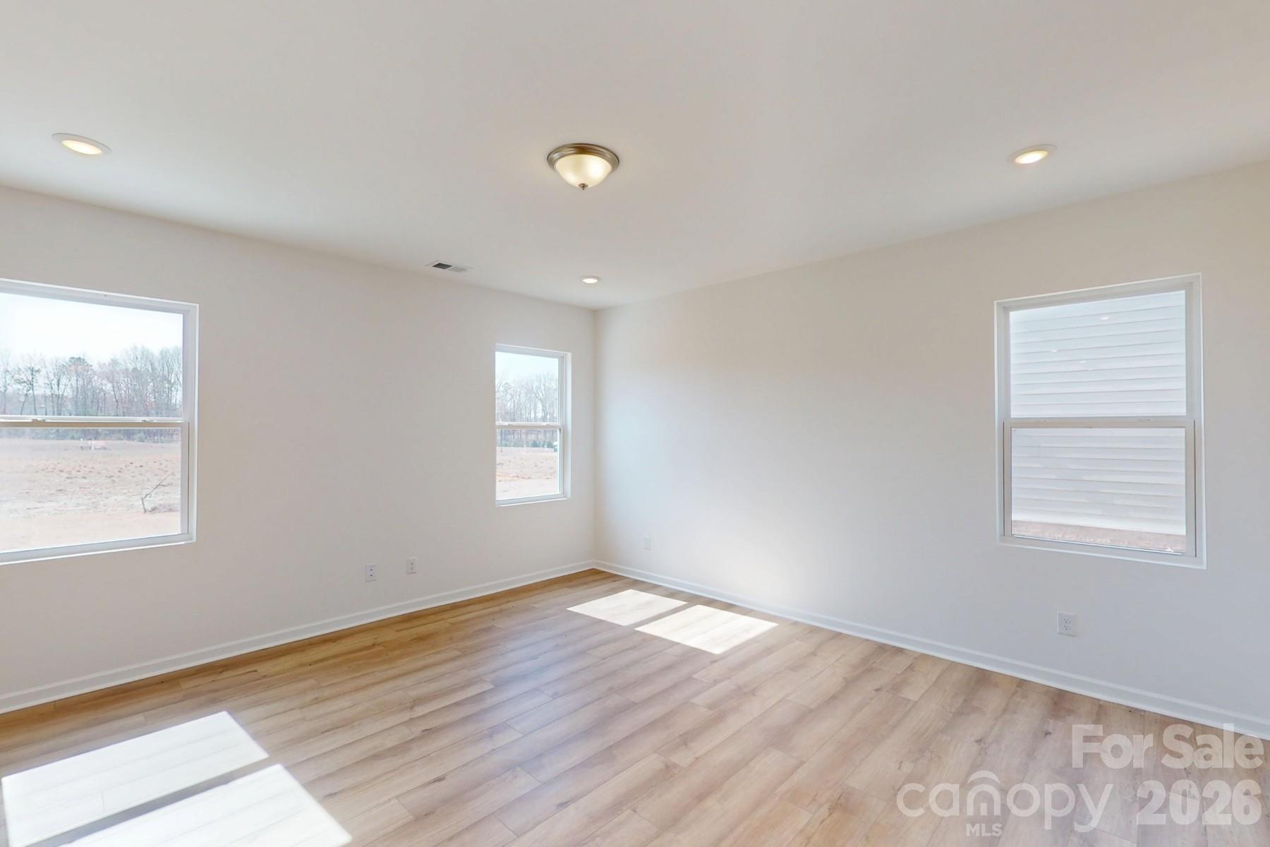 920 Barker Street Monroe, NC 28112 - Photo 14 of 36 a view of an empty room with wooden floor and a window