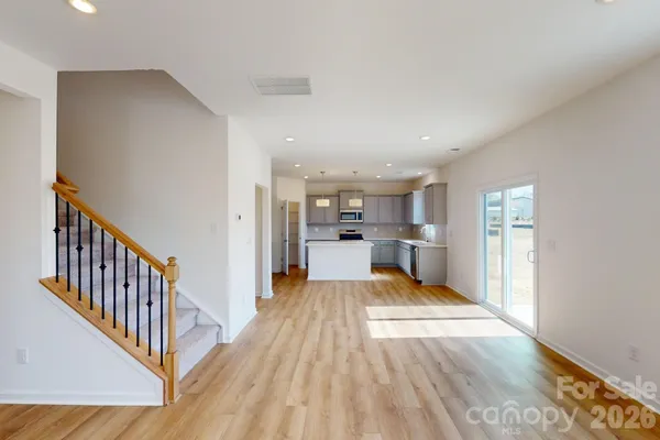 a view of a kitchen with wooden floor and electronic appliances