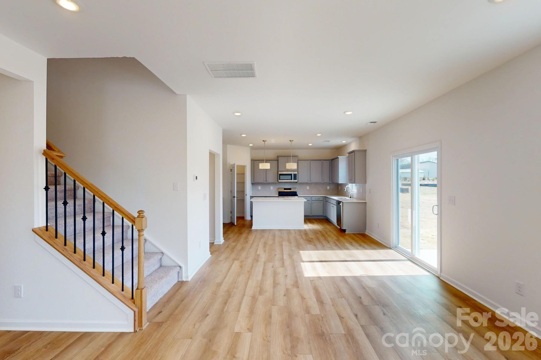 920 Barker Street Monroe, NC 28112 - Photo 18 of 36 a view of a kitchen with wooden floor and electronic appliances