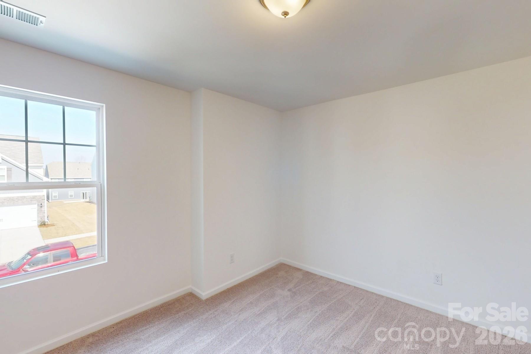 920 Barker Street Monroe, NC 28112 - Photo 22 of 36 an empty room with wooden floor and windows