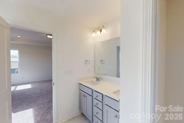 a bathroom with a granite countertop sink two mirror and a