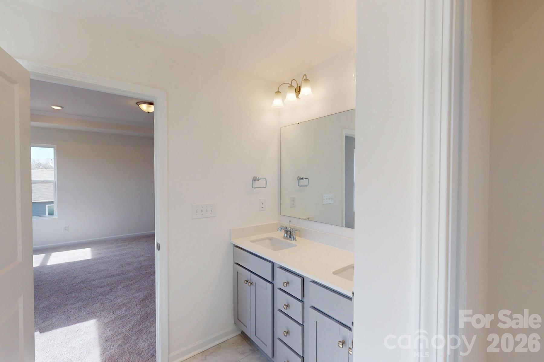 920 Barker Street Monroe, NC 28112 - Photo 29 of 36 a bathroom with a granite countertop sink two mirror and a