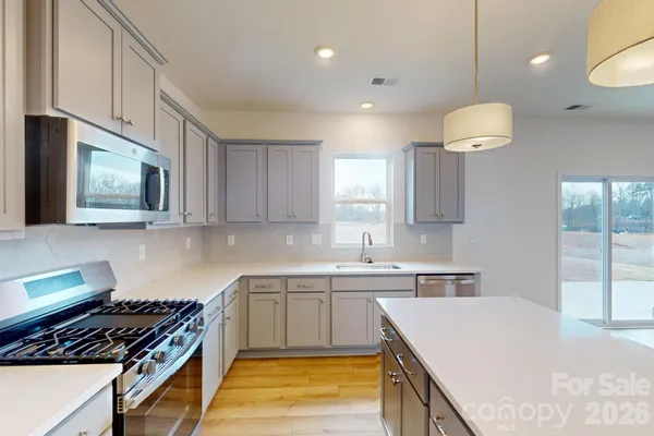 a kitchen with a sink stove and cabinets