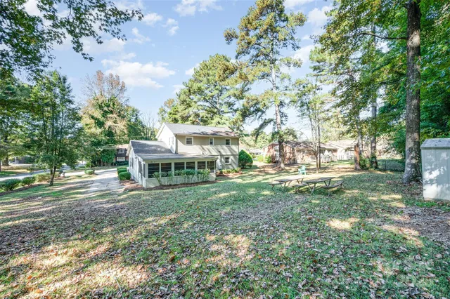 a view of house with backyard