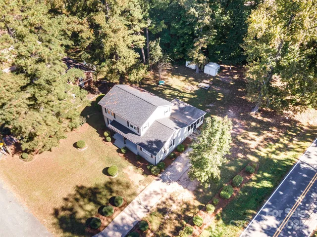 a view of a yard in front of the tree