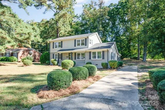 a front view of a house with a garden