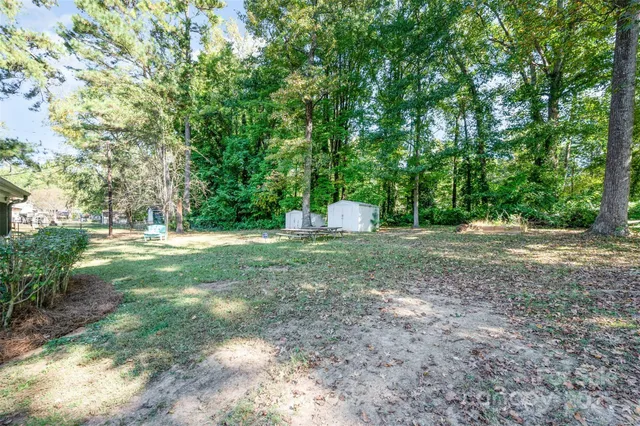 a view of a outdoor space with deck and tree