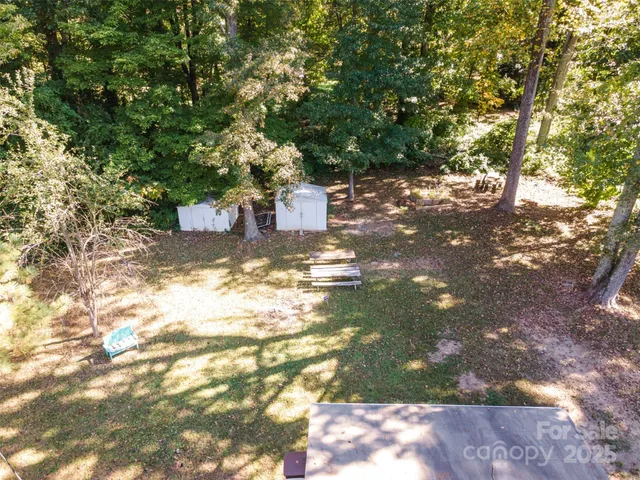 a view of a house with a yard covered in snow