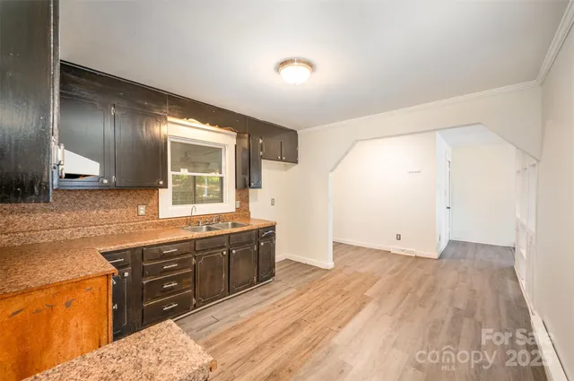 a spacious bathroom with a granite countertop sink and a mirror