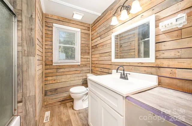 a bathroom with a sink a toilet and a window