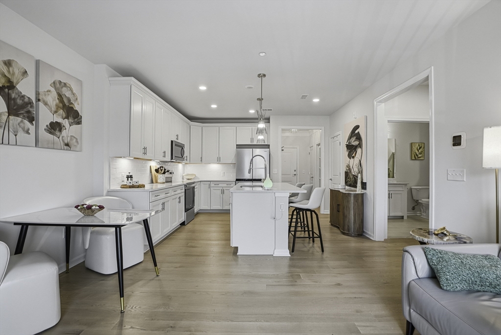 2 Codman Way, Unit 2203 Westborough, MA 01581 - Photo 7 of 36 a living room with stainless steel appliances furniture and wooden floor
