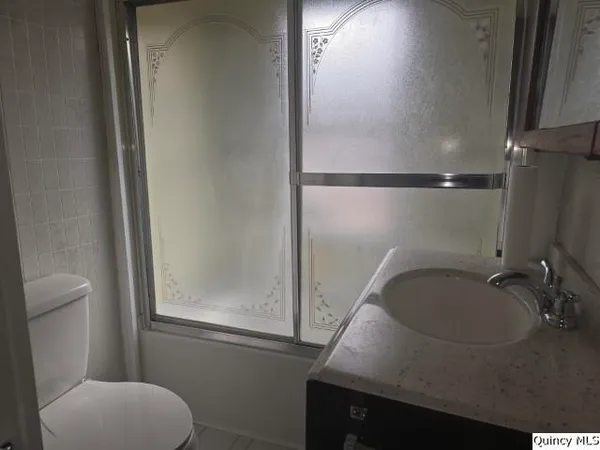a bathroom with a sink toilet and a mirror