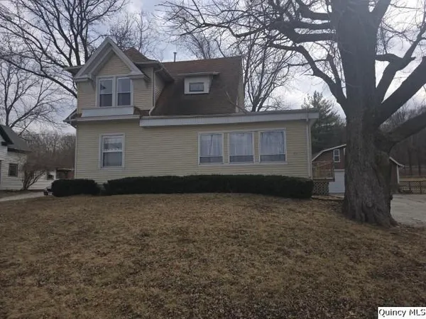 a house that has a tree in front of the house