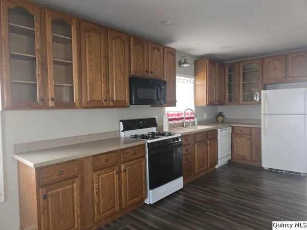a kitchen with a sink stove top oven and refrigerator