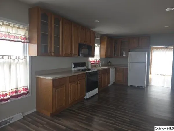 a kitchen with stainless steel appliances a refrigerator sink and microwave