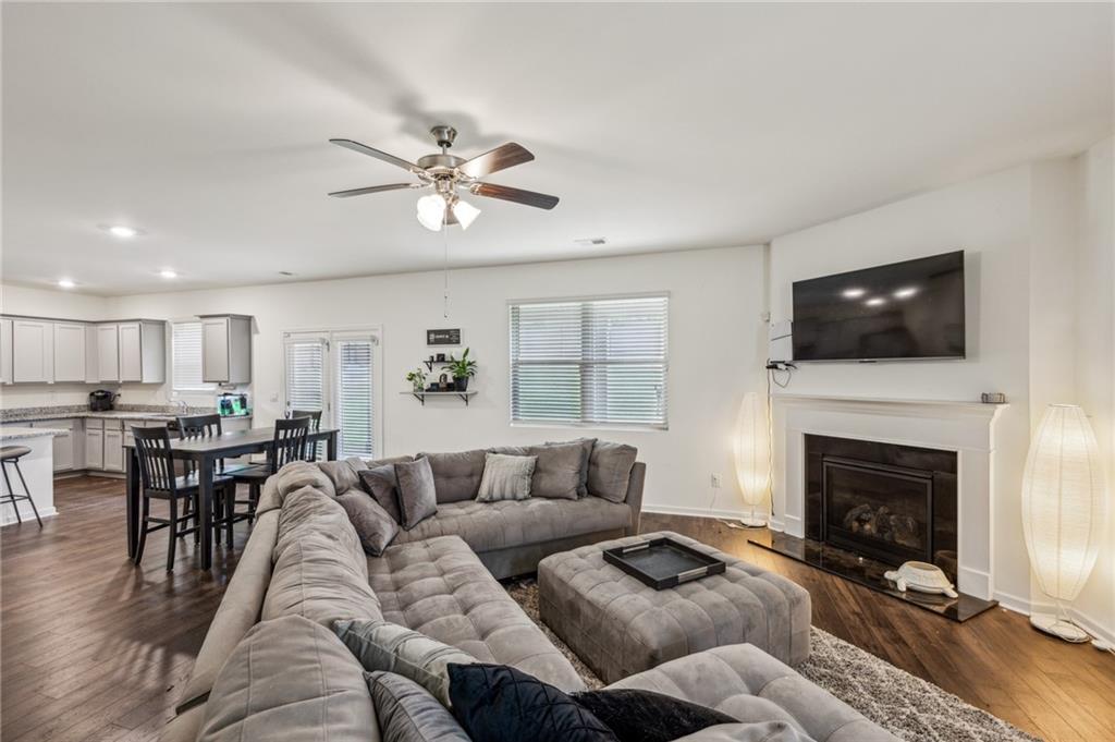 5320 Flat Rock Point Lithonia, GA 30038 - Photo 12 of 35 a living room with furniture a fireplace and a flat screen tv