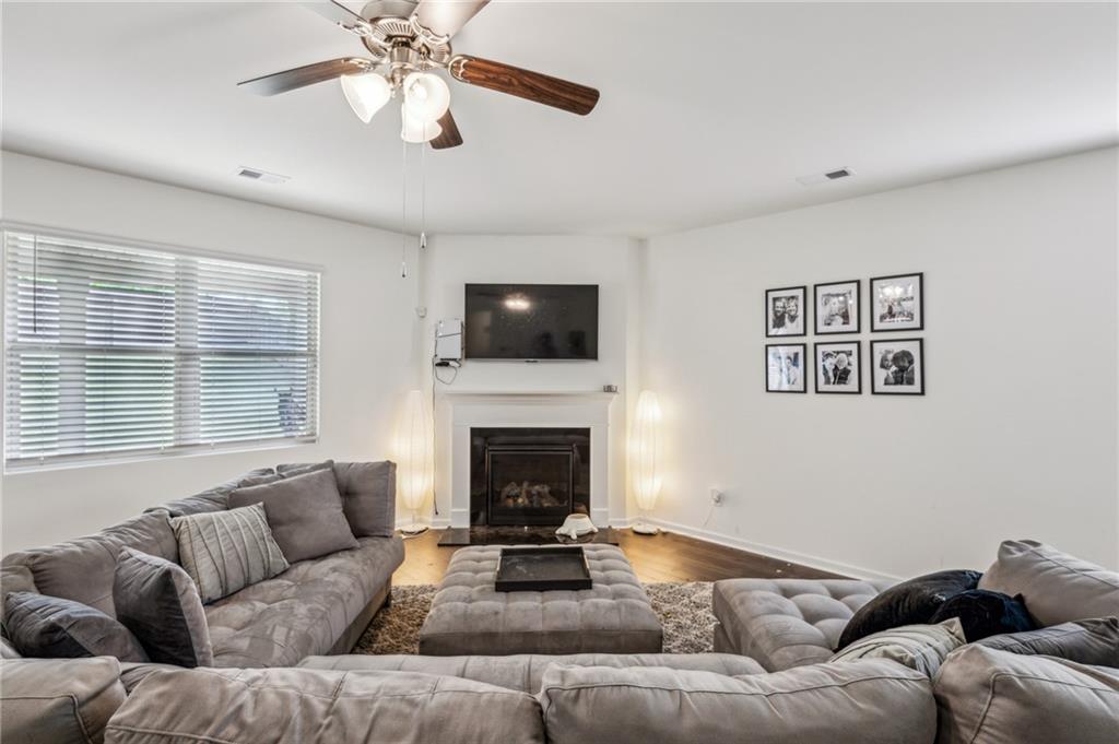 5320 Flat Rock Point Lithonia, GA 30038 - Photo 13 of 35 a living room with furniture a fireplace and a flat screen tv
