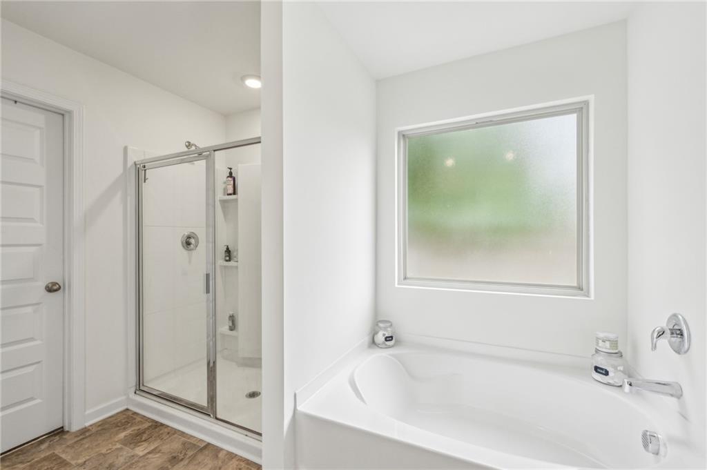 5320 Flat Rock Point Lithonia, GA 30038 - Photo 19 of 35 a bathroom with a bathtub and shower