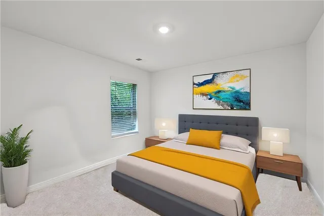 a bedroom with a bed and painting on the wall