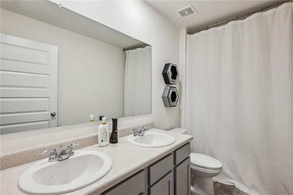 5320 Flat Rock Point Lithonia, GA 30038 - Photo 25 of 35 a bathroom with a sink toilet and mirror