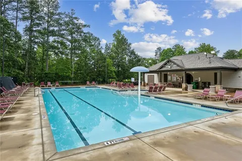 a swimming pool with outdoor seating and yard