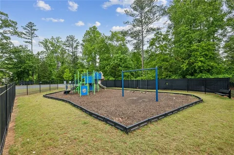 a view of a backyard with swimming pool