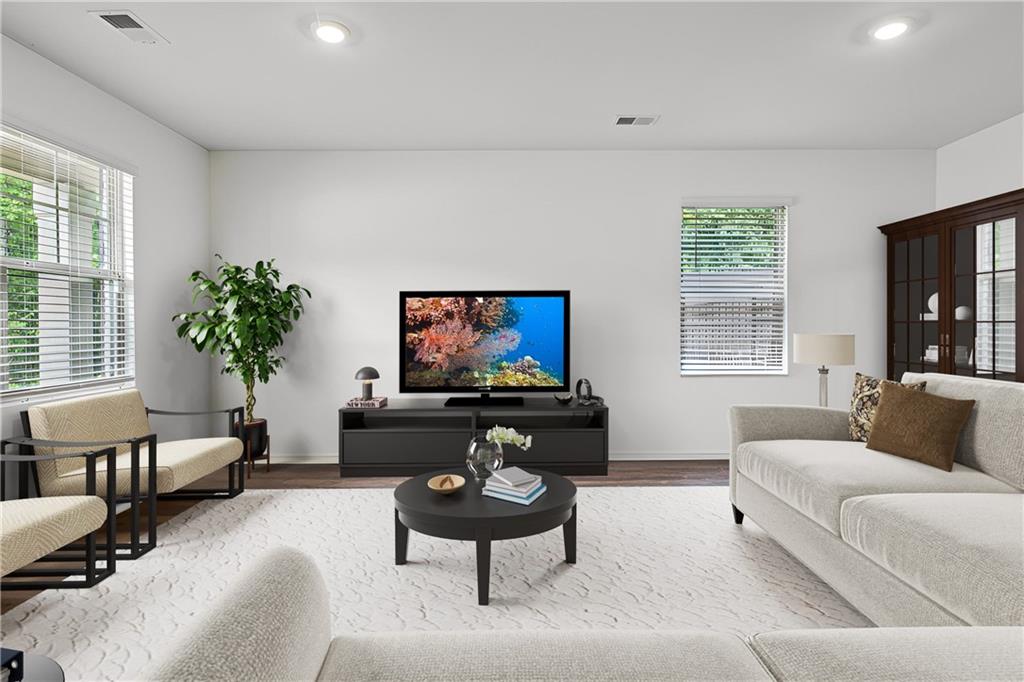 5320 Flat Rock Point Lithonia, GA 30038 - Photo 5 of 35 a living room with furniture a flat screen tv and a large window