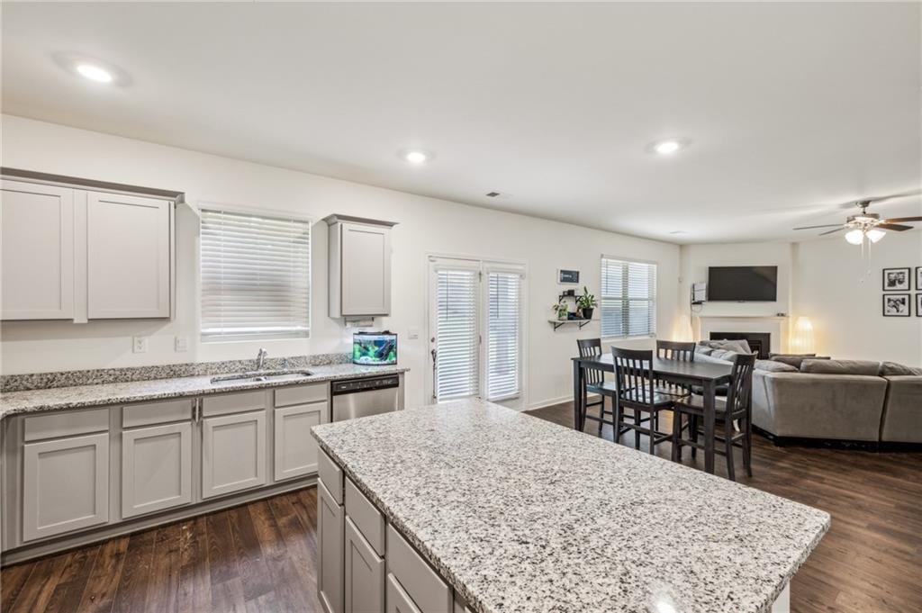 5320 Flat Rock Point Lithonia, GA 30038 - Photo 8 of 35 a kitchen with stainless steel appliances granite countertop sink stove top oven and cabinets