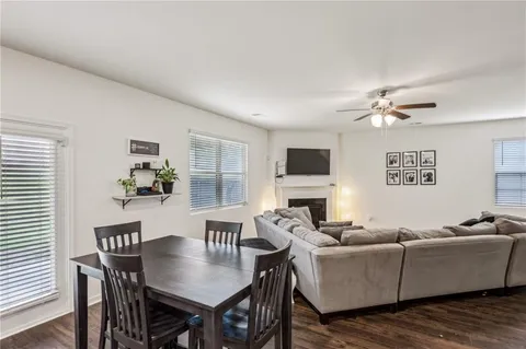 a living room with furniture kitchen view and a window