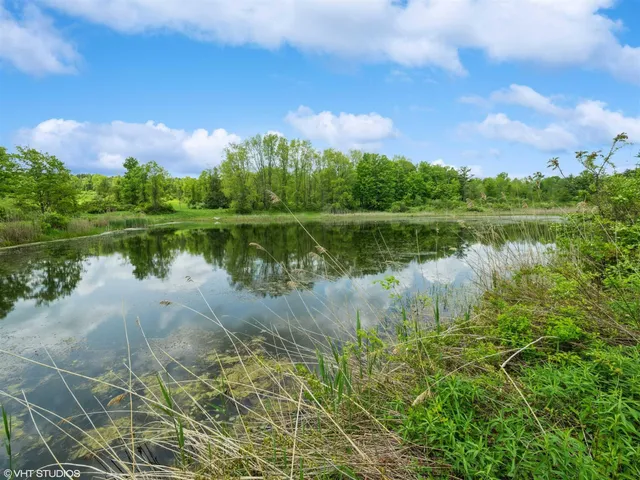 a view of a lake with a house in the background