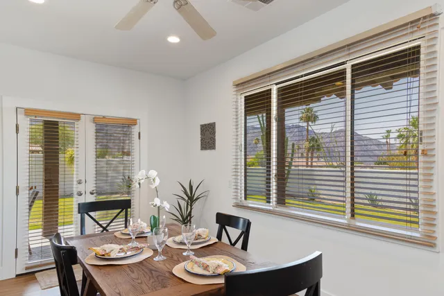 a living room with furniture and large windows