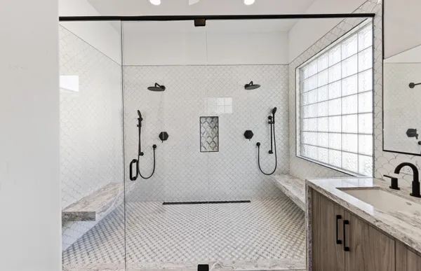 a bathroom with a granite countertop sink a toilet and shower