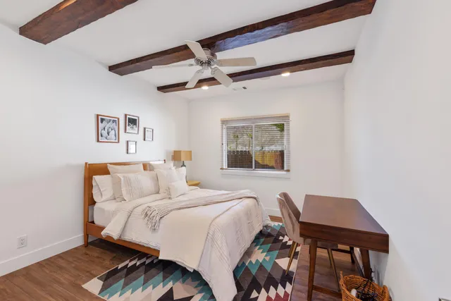 a bedroom with a bed and a table