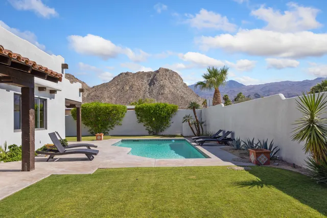 a view of a swimming pool with a yard
