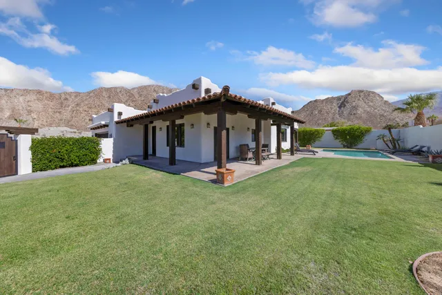 a view of a house with a yard and front view of a house