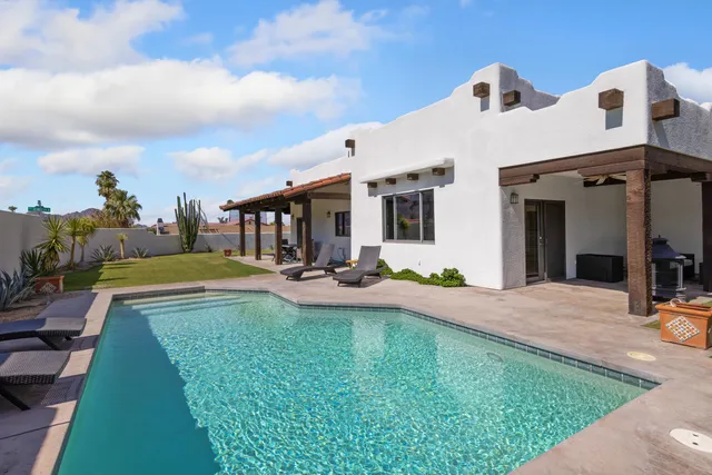 a view of a house with swimming pool and porch