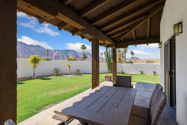 a view of a backyard with sitting area