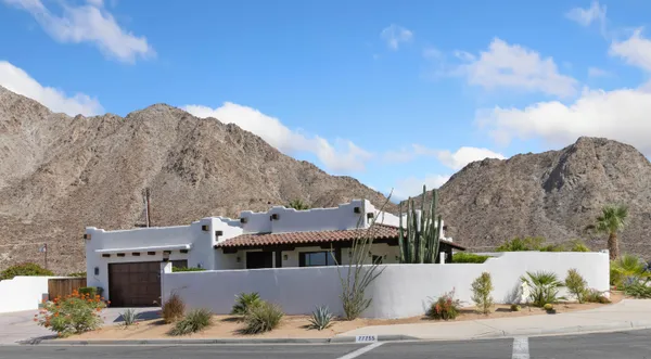a view of a big house with a mountain in the background