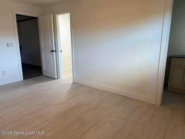 an entryway with wooden floor