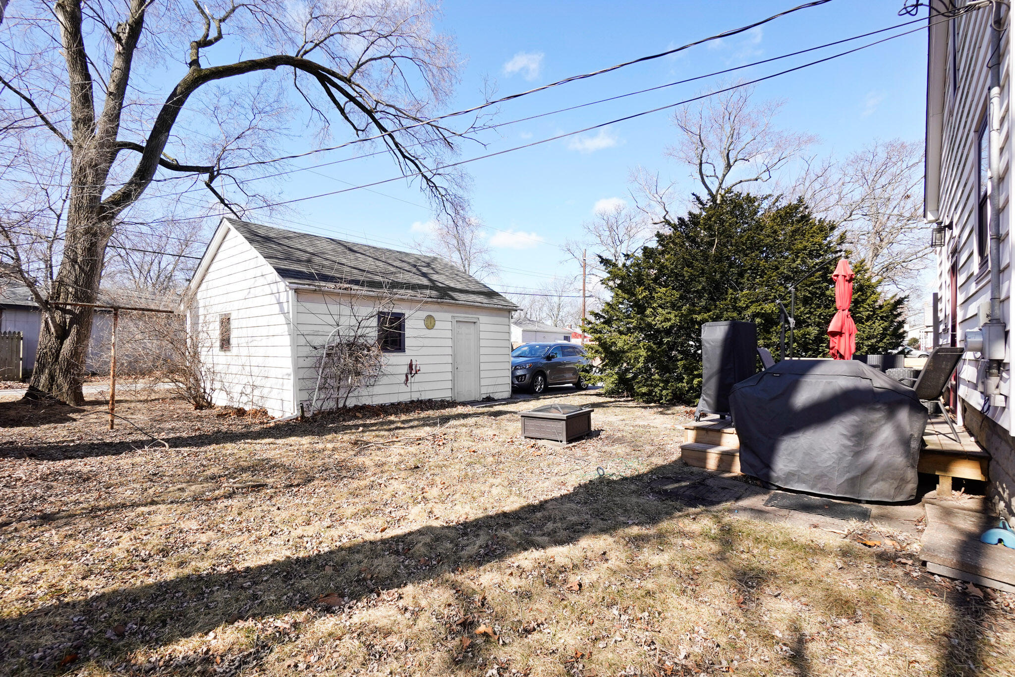 244 Dwiggins Griffith, IN 46319 - Photo 15 of 15 a backyard of a house with table and chairs under an umbrella