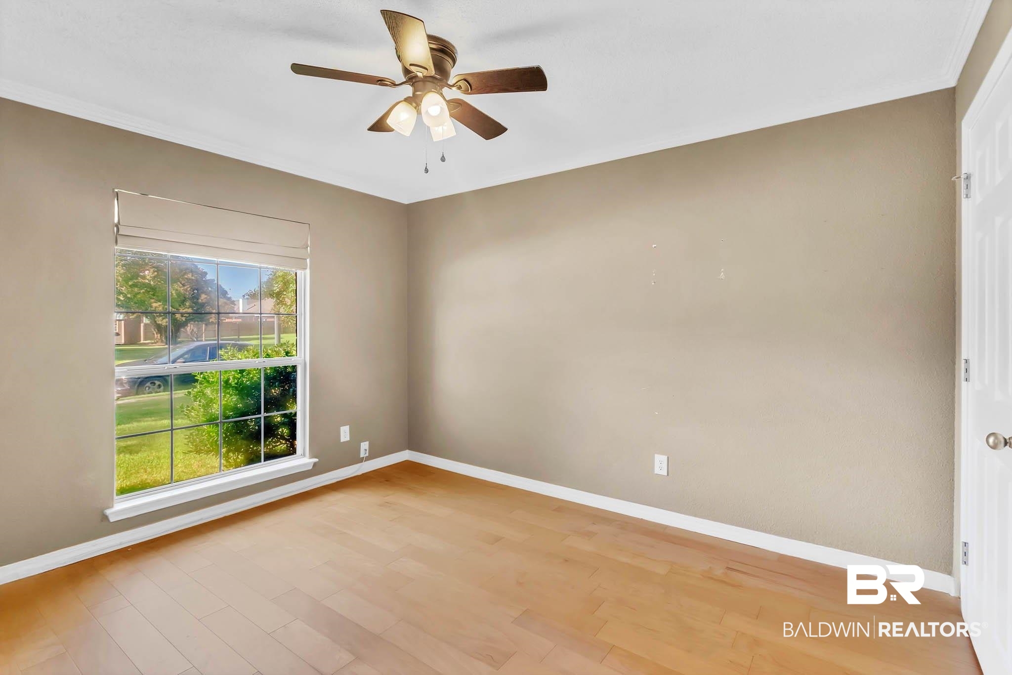9607 Czar Court Fairhope, AL 36532 - Photo 27 of 42 Empty room with light wood-type flooring, ceiling fan, and ornamental molding