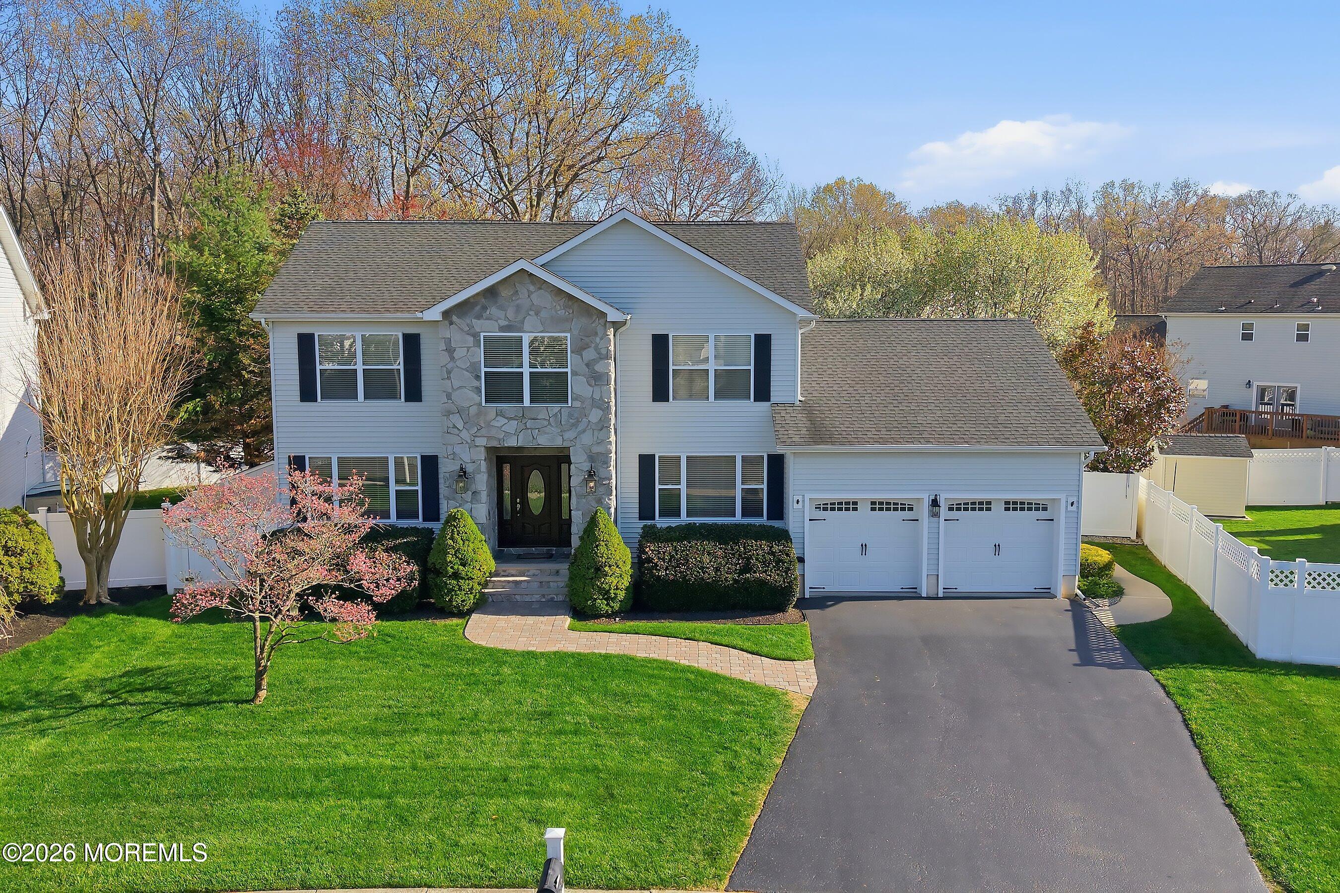 23 Paulette Lane Howell, NJ 07731 - Photo 1 of 35 a front view of a house with a garden and plants