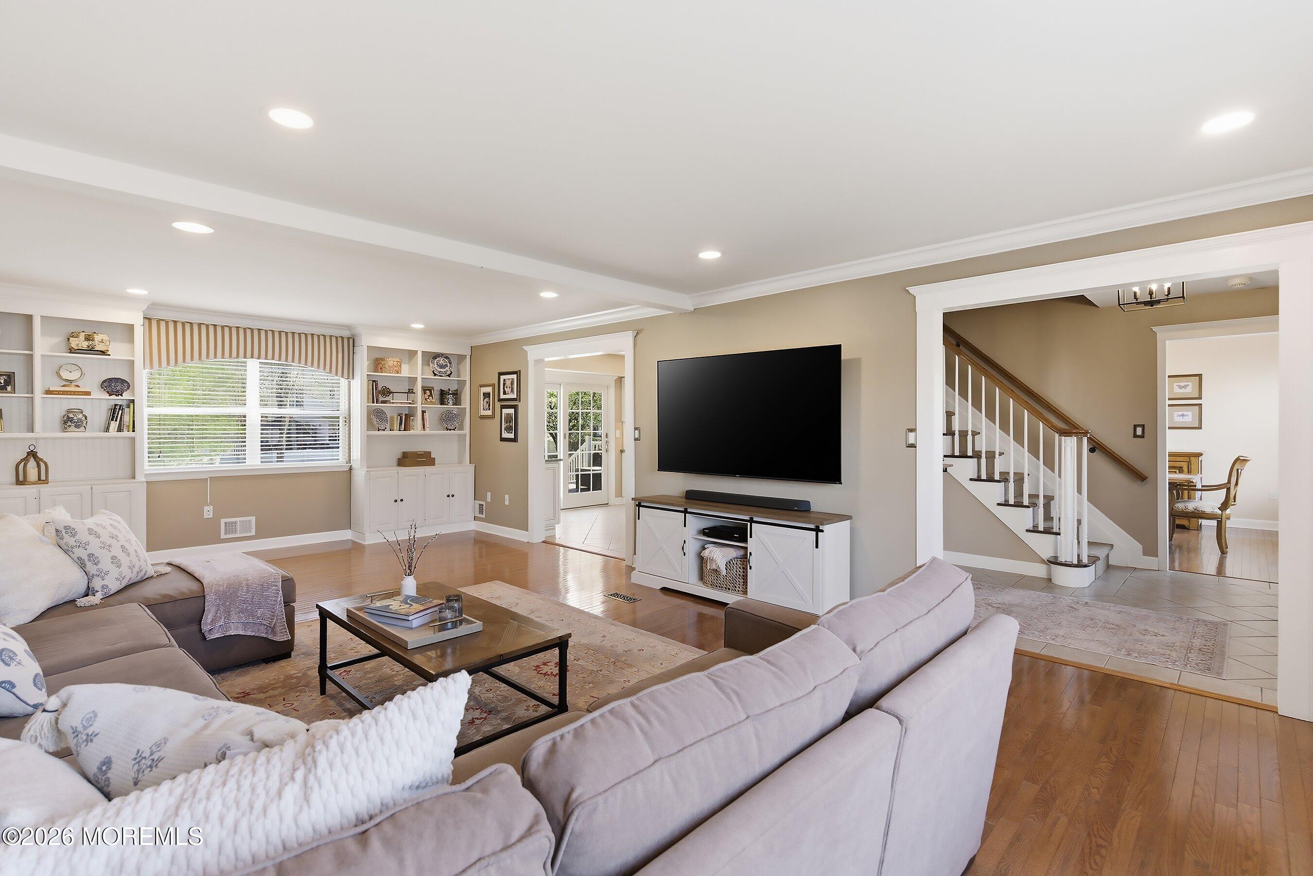 23 Paulette Lane Howell, NJ 07731 - Photo 12 of 35 a living room with furniture and a flat screen tv