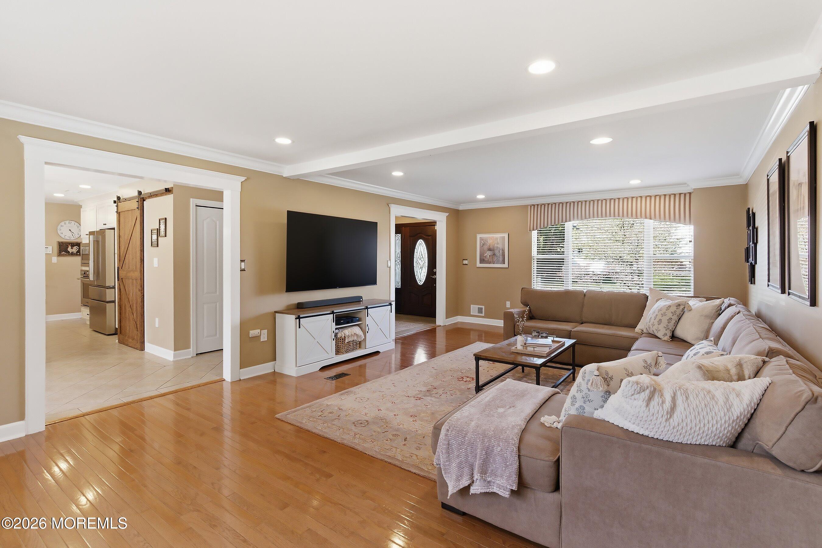 23 Paulette Lane Howell, NJ 07731 - Photo 13 of 35 a living room with furniture and a flat screen tv