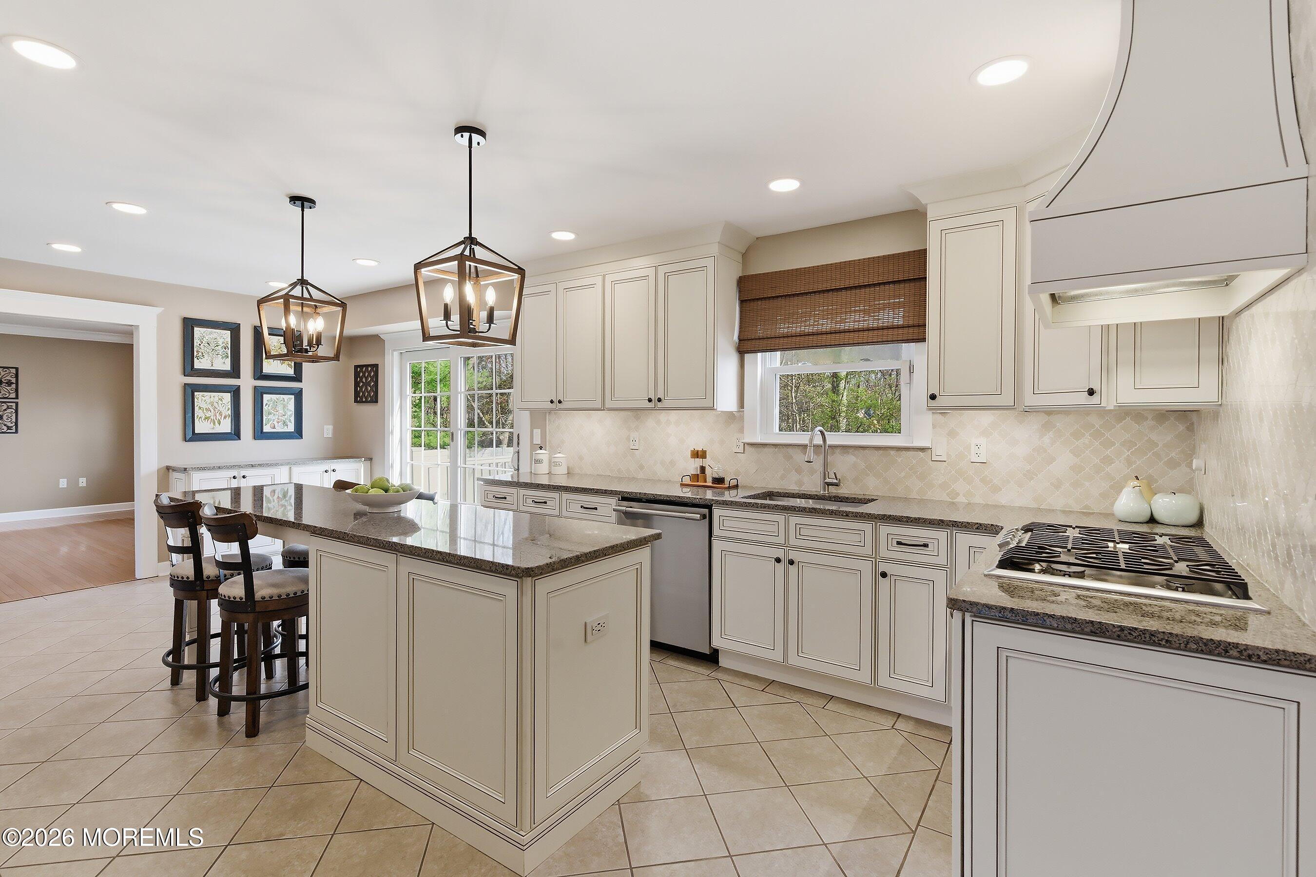23 Paulette Lane Howell, NJ 07731 - Photo 15 of 35 a kitchen with granite countertop a sink stove and cabinets