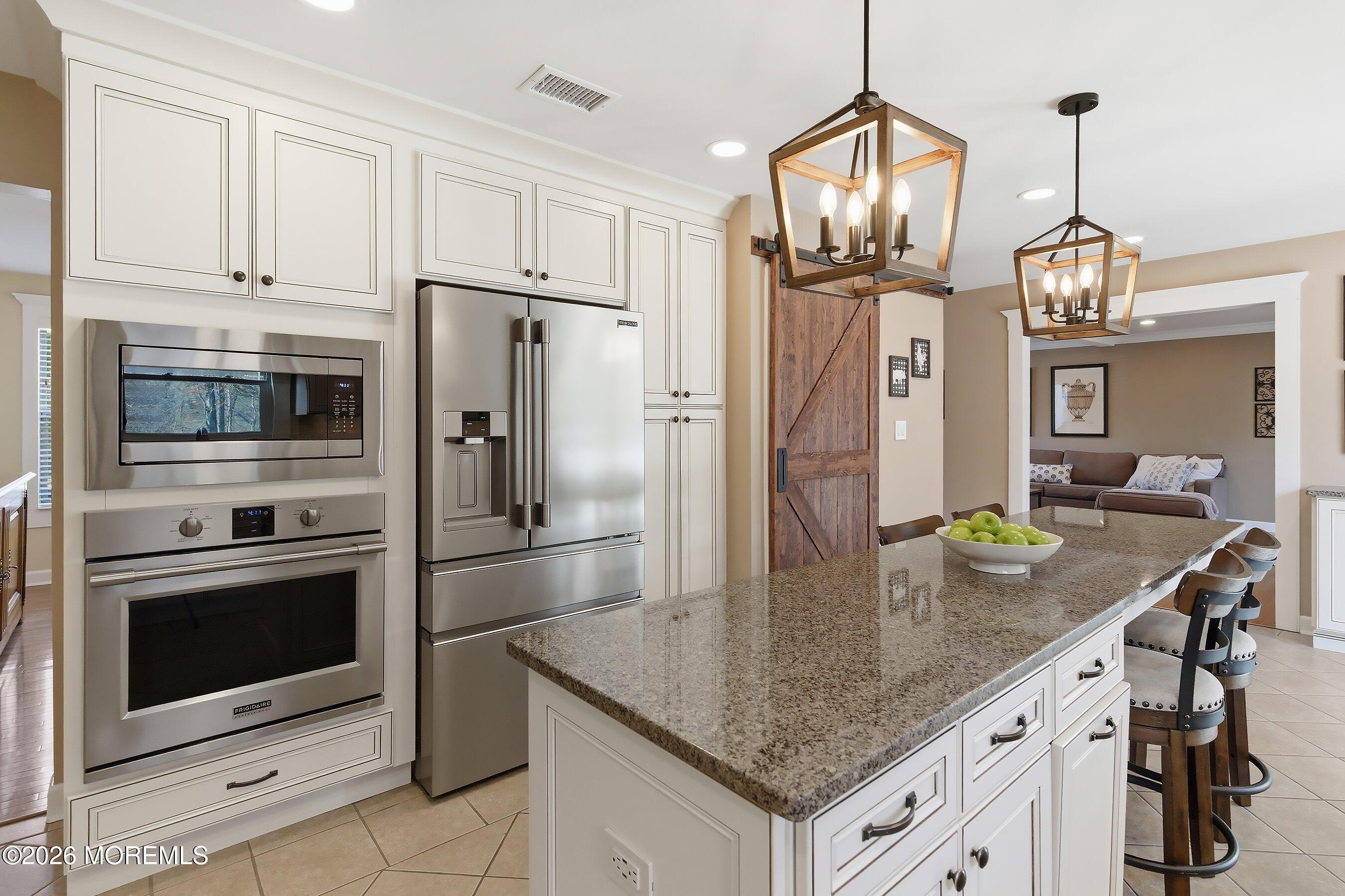 23 Paulette Lane Howell, NJ 07731 - Photo 16 of 35 a kitchen with stainless steel appliances granite countertop a sink refrigerator and cabinets
